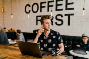 A small business owner in a coffee shop that represents an exempted micro enterprise.