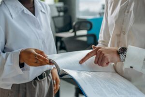 A pair of professionals reviewing the employment equity report